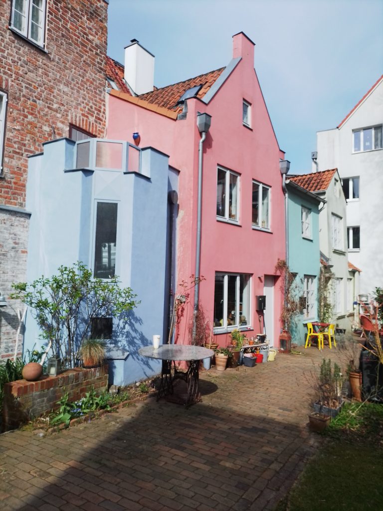 Bunte Altstadthäuser in einem Gang der Lübecker Altstadtinsel. Kostenlos mit Quellenangabe nutzbar.